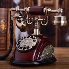 an old fashioned phone sitting on top of a wooden table