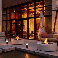 a fire pit sitting on top of a patio next to a building