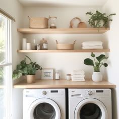 a washer and dryer sitting next to each other on top of wooden shelves