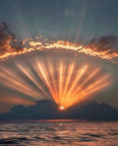 the sun is shining brightly in the sky over the ocean as it reflects on the water