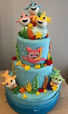 a three tiered cake decorated with sea animals and fish on it's sides