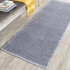 a blue and white rug on the floor