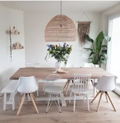 a dining room table with white chairs around it