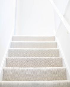 white carpeted stairs leading up to the top floor