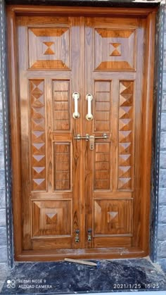 two wooden doors with decorative designs on the front and side panels, one is made out of wood