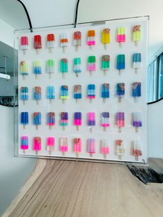 an ice cream display with popsicles and sprinkles on the wall behind it