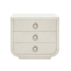 a white nightstand with three drawers and two knobs on the front, one drawer open