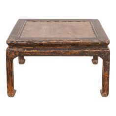 an old wooden table with a cushion on it's top and legs, against a white background