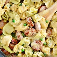 a bowl filled with pasta and peas on top of a table