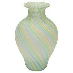 a green and white striped vase on a white background