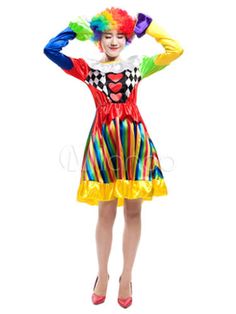 a woman in clown makeup and colorful hair is posing with her hands on her head