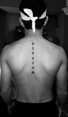 the back of a man's head with words written on his neck and chest