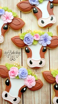 some decorated cookies with flowers on them and a cow's face in the middle