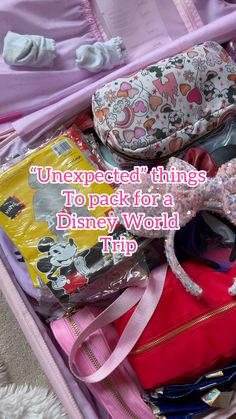 an open suitcase filled with lots of disney world items and the words, unexpected things to pack for a disney world trip