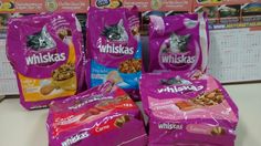 three bags of whiska's cat food on display