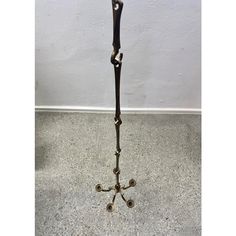 a metal floor lamp with three candles on it