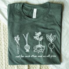 This short sleeve t-shirt features the phrase "root for each other and we all grow" and hand drawn line art illustrations of root vegetables. It is a super soft cotton blend that feels like a well-loved favorite from day one. You've found the perfect gift for the dietitian, vegetarian, vegan, cook, or general vegetable-lover in your life! Or keep it in your own wardrobe :) Choose from 5 shirt colors in the drop down menu. The design will be printed in white ink on all colors. All options are hea