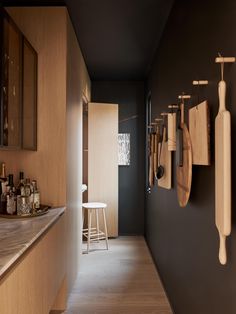 a kitchen with wooden utensils hanging on the wall next to a counter top