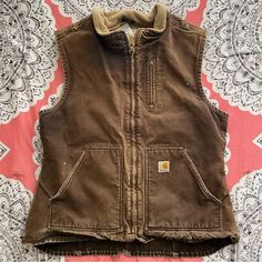 Euc. Distressed. Gorgeous Vest! Color: Dark Brown. Heavyweight Cotton Duck Vest With Warm Lining. Carhartt Strong, Triple Stitched Main Seams. Full Zip Front. Droptail Hem. Chest Pocket. Two Front Pockets. Two Inner Pockets. C407 Firm Price Eminent Domain, Carhartt Vest, Carhartt Jackets, Brown Vest, Carhartt Women, Carhartt Womens, Hunting Clothes, Cute Outfit Ideas, Women's Vest