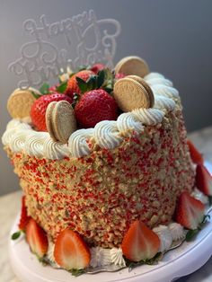 there is a cake with cookies and strawberries on it