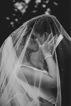 a dreamy noir wedding shot showcasing veil in romantic way Veil Pictures Wedding Couple, Under Veil Photo, Courthouse Wedding Veil, Wedding Day Shots Photo Ideas, Under The Veil Wedding Photos, Veil Photoshoot, Noir Wedding, Botanical Wedding Theme, Photography Examples