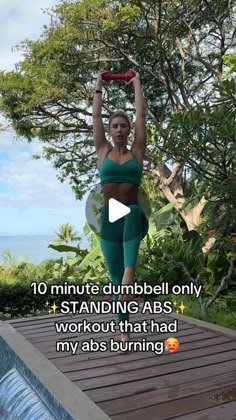 a woman is doing yoga in front of a pool