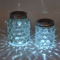 two mason jars sitting on top of a table next to each other with the words easy mason jar luminaries