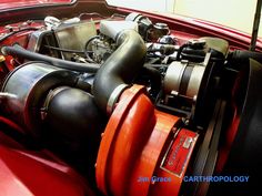 the engine compartment of an old red car