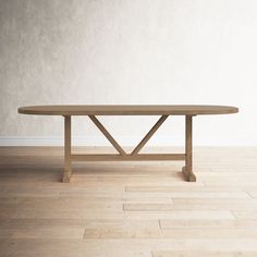 a wooden table sitting on top of a hard wood floor next to a white wall