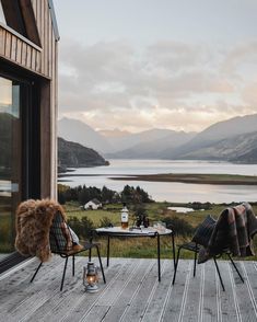 two chairs sitting on top of a wooden deck