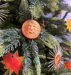 a christmas tree decorated with sun and fish ornaments