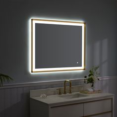 a bathroom with a sink, mirror and lights on the wall above it is shown