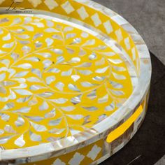 a yellow and white plate sitting on top of a table