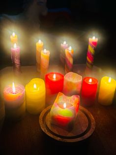 many lit candles are arranged on a table