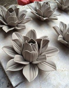 several clay flowers sitting on top of a table