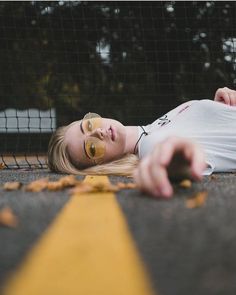 a woman laying on the ground wearing goggles