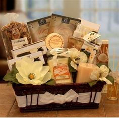 a basket filled with lots of different items on top of a table next to candles