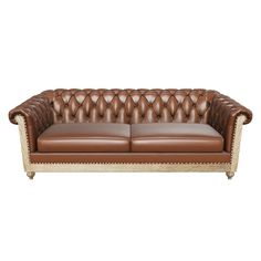 a brown leather couch with gold trimmings and nail polishing on the arms