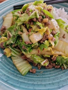 a blue plate topped with lettuce and meat