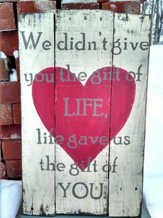 a wooden sign that says we didn't give you the gift of life, like gave us the gift of you