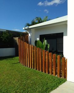 a wooden fence in front of a white house