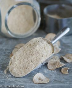 a spoon full of powdered sugar next to some other ingredients on a counter top