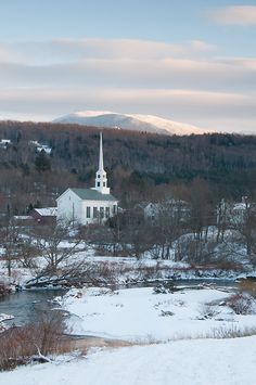 a church in the middle of a snowy landscape