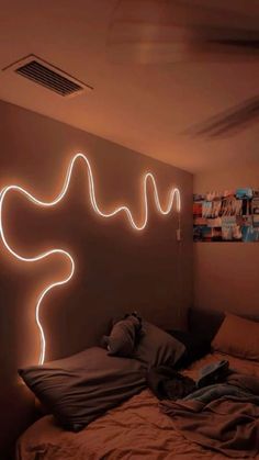 a room with a bed and some lights on the wall