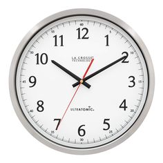 an analog clock with red hands and numbers on the face is shown against a white background