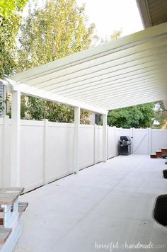 an outdoor covered patio area with white walls