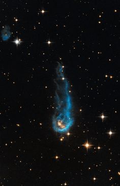 an image of a very bright blue object in the middle of some dark space with stars