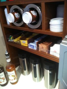 the shelves are filled with cups and other items