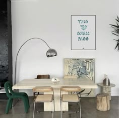 a table and chairs in a room with white walls