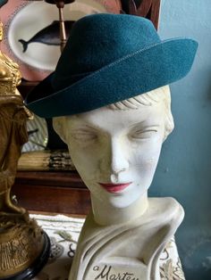 Here we have a cute little late 1930s soft  felt hat in a lovely teal colour. Makers name "Kenbrook Morrison" 'Pixie' style hat that perches on the head. In very good condition. Shown on a 21" mannequin head... measures 20.5" circumference inside. Vintage Felt Hat With Short Brim, Vintage Short Brim Felt Hat, Vintage Wide Brim Felt Hat, Vintage Green Fedora With Short Brim, Green Vintage Mini Hat With Short Brim, Green Vintage Fedora With Short Brim, Vintage Green Fedora Hat Band, Vintage Green Mini Hat With Short Brim, Vintage Blue Mini Hats With Short Brim